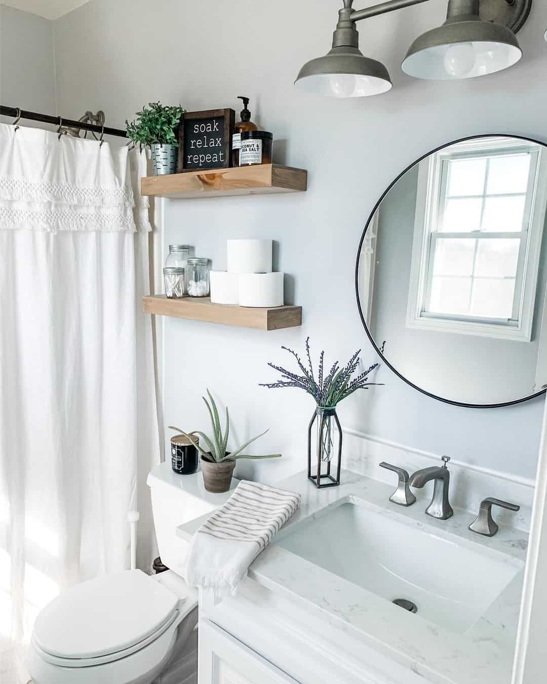 White Bathroom with Circular Black Mirror Soul & Lane