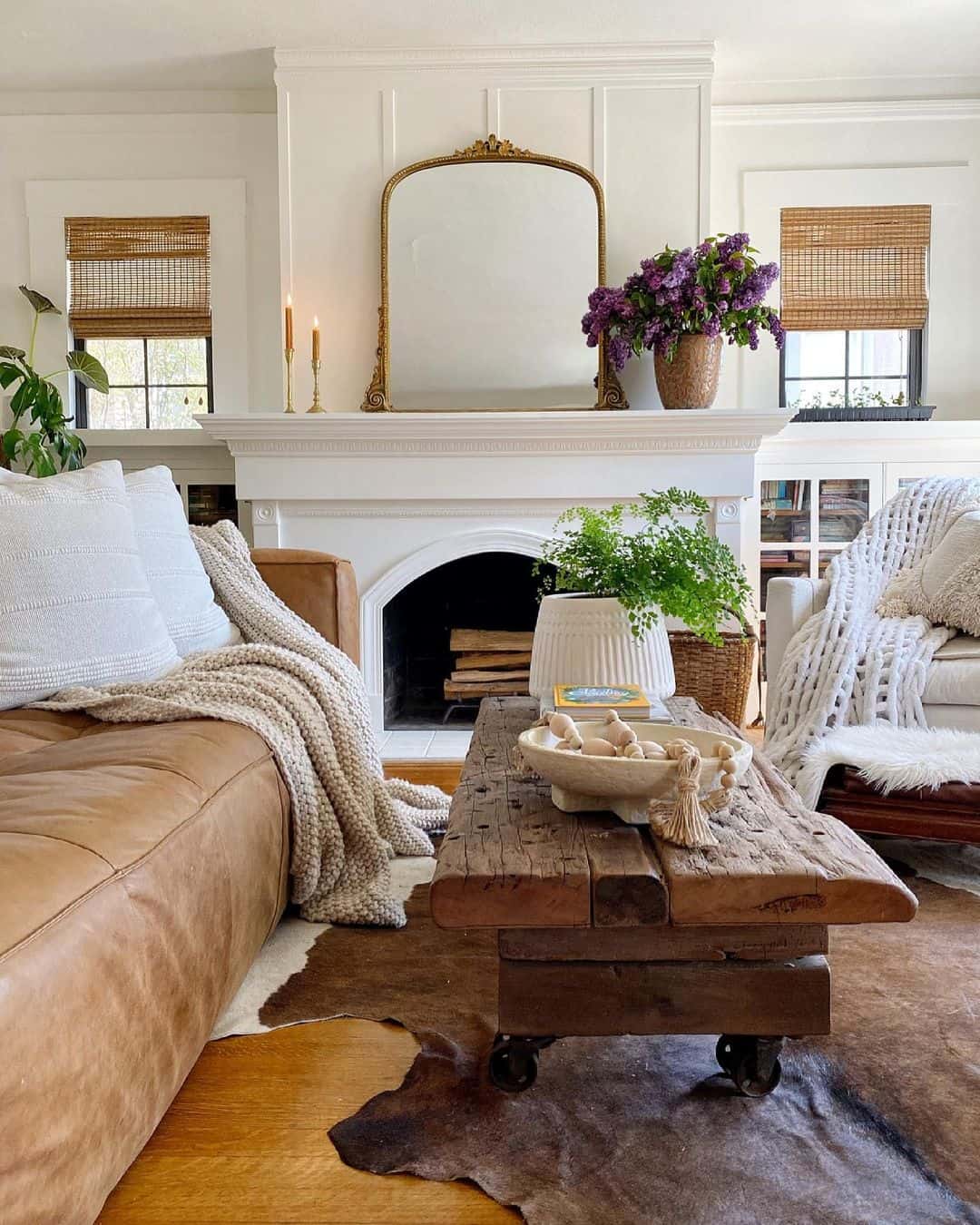 White Fireplace and Brown Leather Couch - Soul & Lane