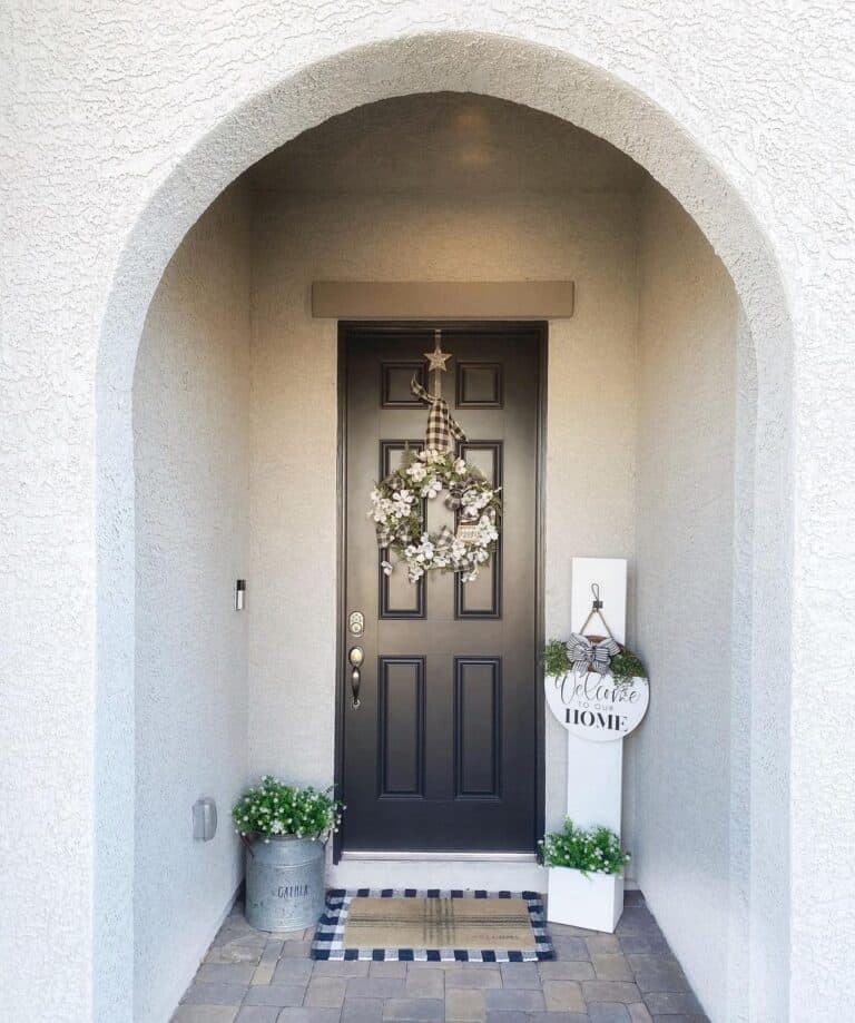 6 Panel Black Front Door and an Arched Doorway