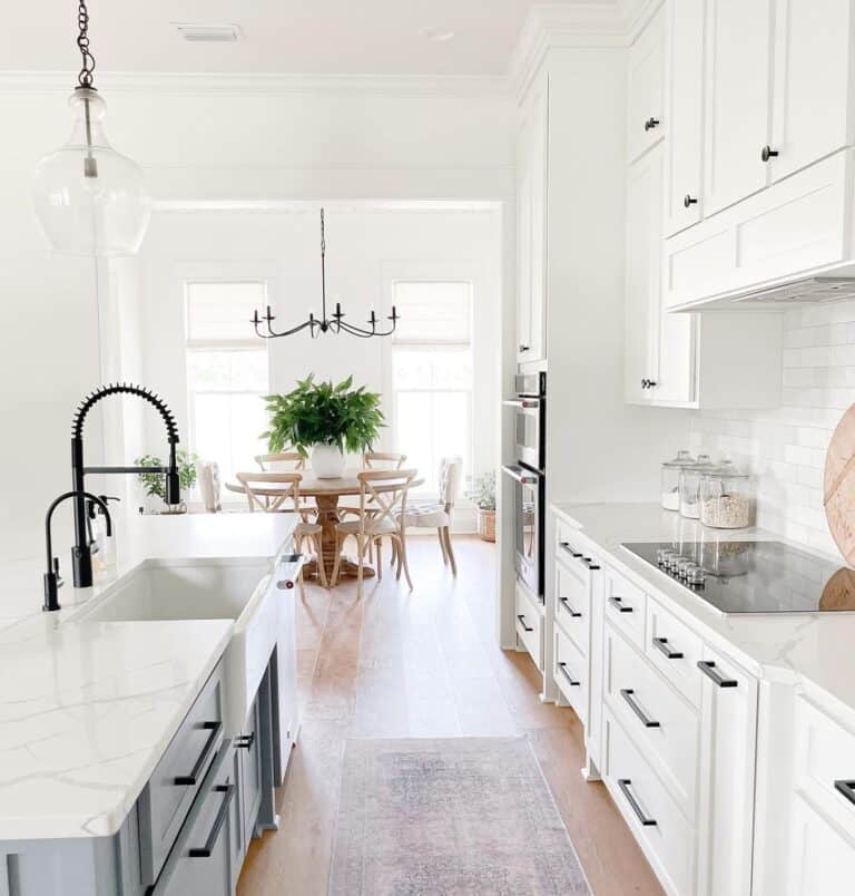 Airy White Kitchen with Gray Island and Dining Table