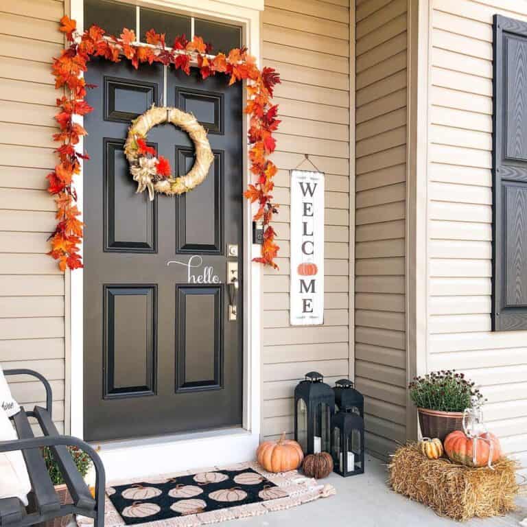 Beige Home with Black Front Door and Fall Decor