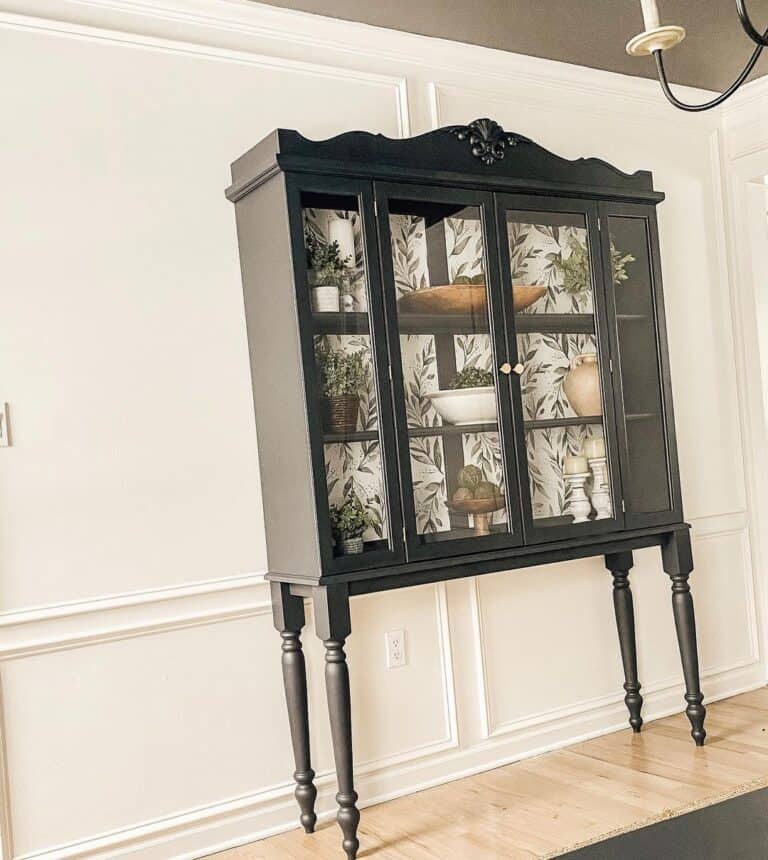 Black Display Cabinet Against Tall White Wainscoting