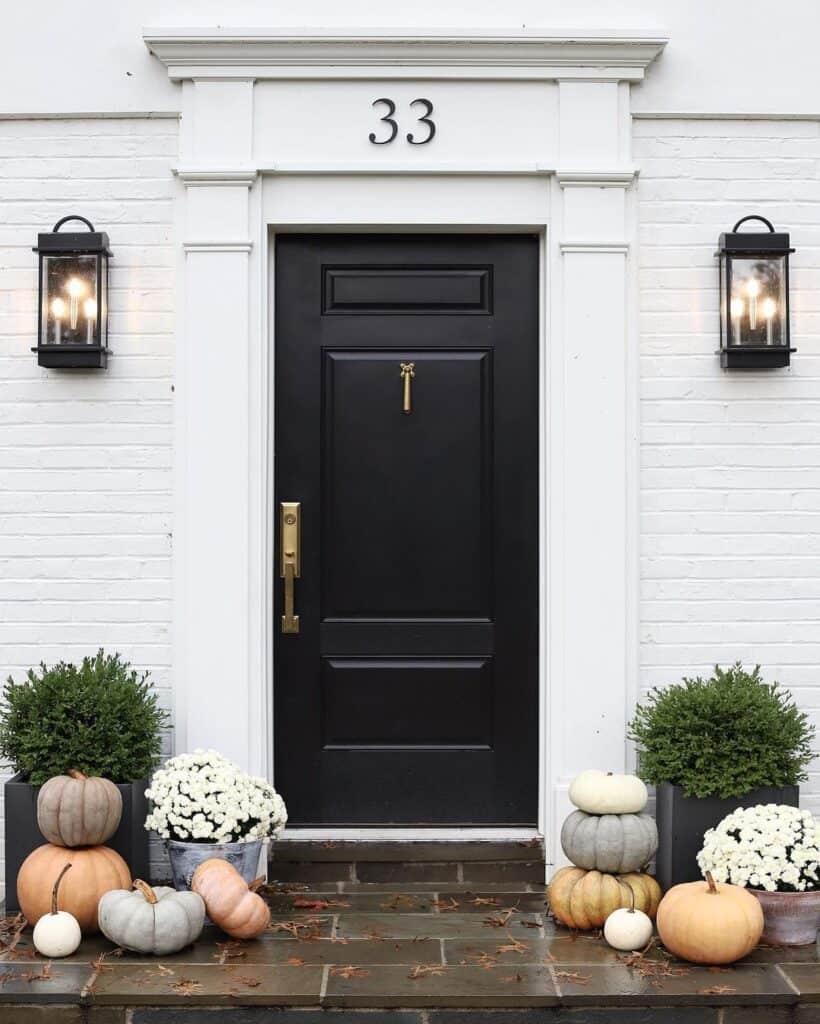 Black Door on a White House With Brass Hardware