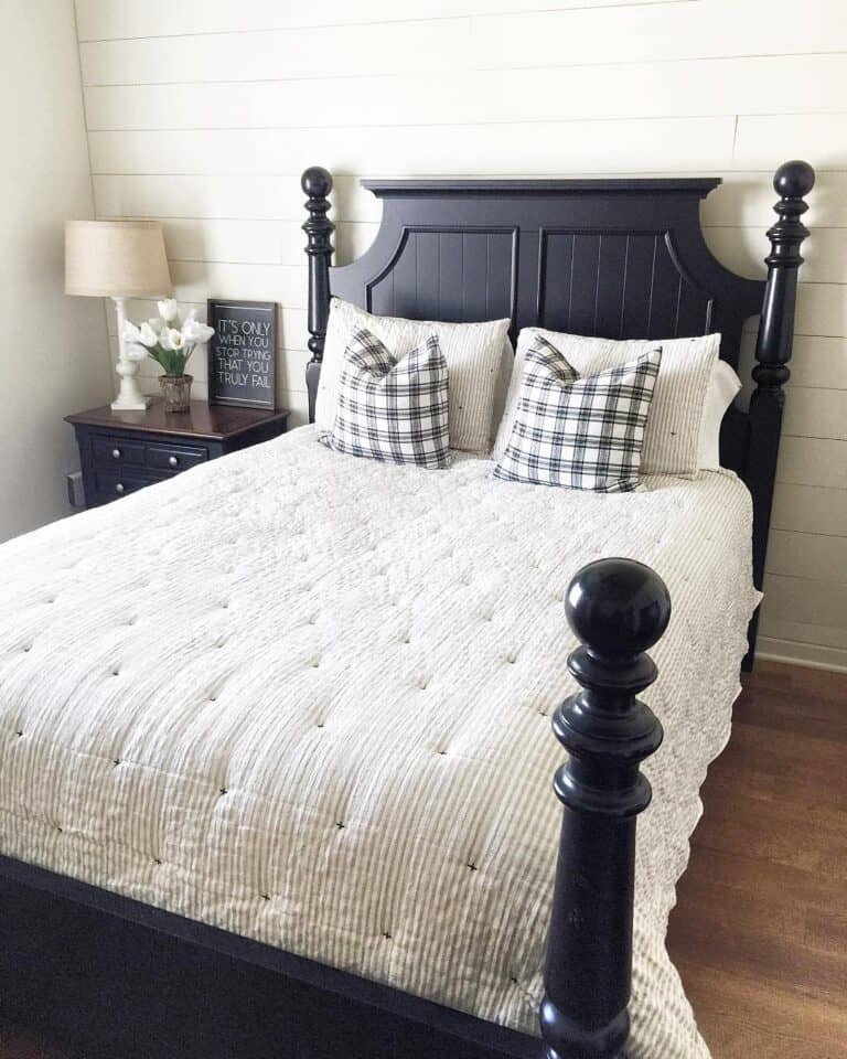 Black Four Poster Bed with Striped Quilt