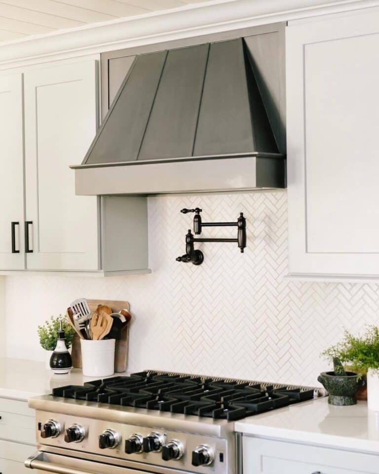 Black Pot Filler on Herringbone Tile Wall