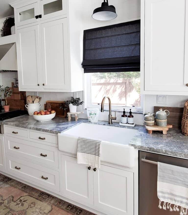 Black Roman Shade Over Brass Kitchen Faucet
