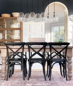 Black Wood Dining Chairs on a Reddish Area Rug