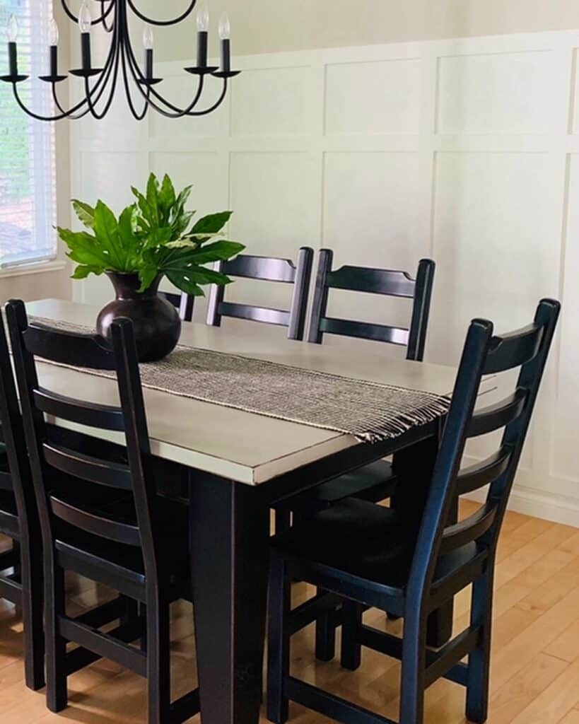 Black Wooden Dining Chairs and White Wainscoting