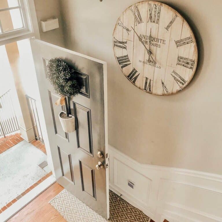 Paneled Front Door Opens to Wainscoting Entryway