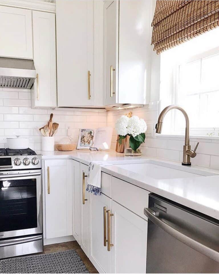 Brass Faucet With a Sprayer on White Countertop