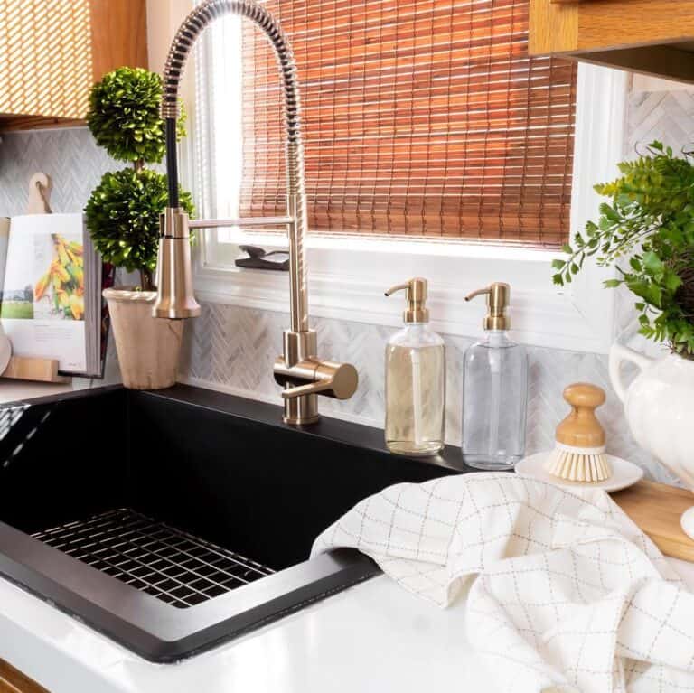 Brass Faucet and a Light Blue Herringbone Backsplash