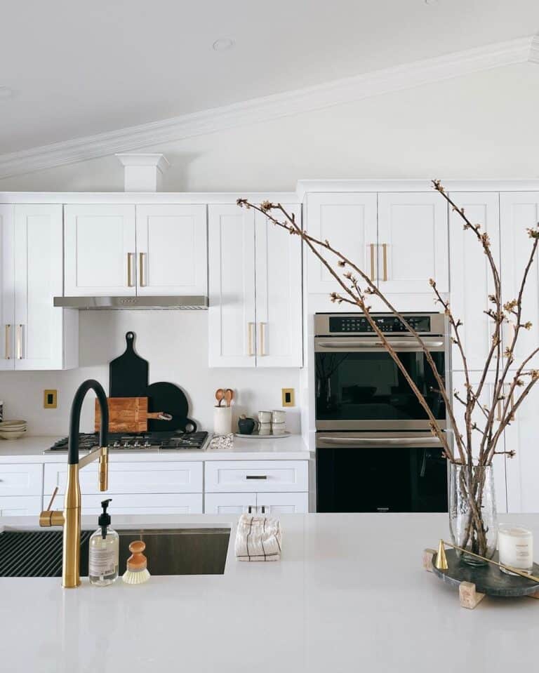 Brass  and Black Faucet on Light Grey Counter