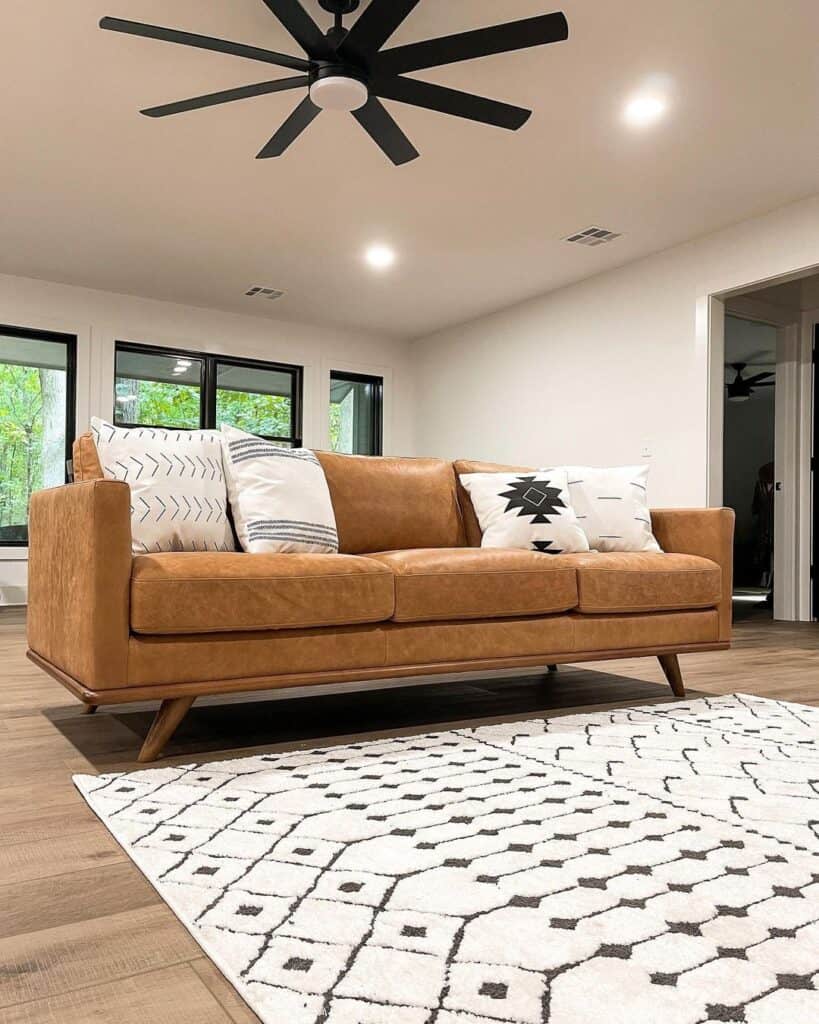 Brown Leather Couch with White and Black Throw Pillows