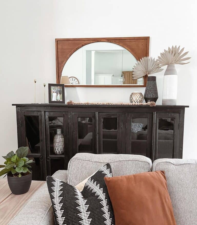 Brown Mirror Over a Black Sideboard