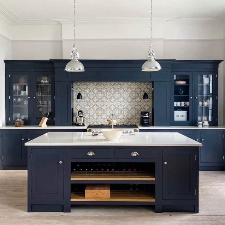 Dark Blue Shaker Cabinets with Crown Molding and Silver Hardware