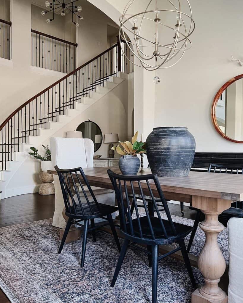 Dining Room with Curved Black and White Staircase - Soul & Lane