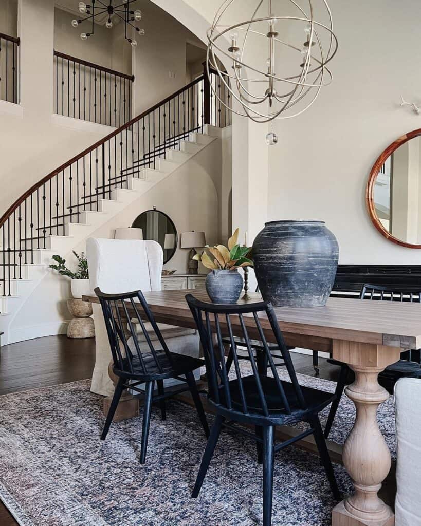 Dining Room with Curved Black and White Staircase