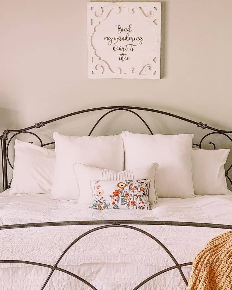 Floral Accent Pillow on Vintage Bedframe