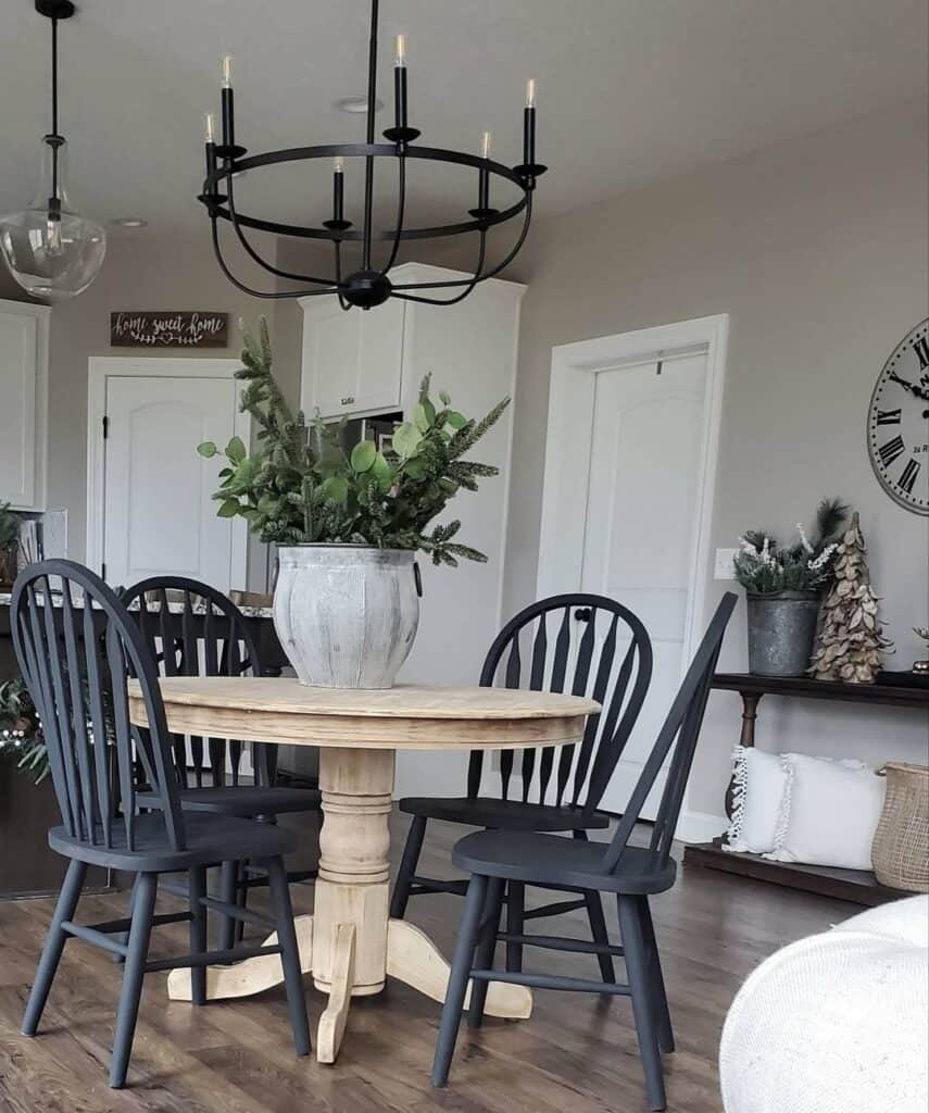 Four Black Wooden Dining Chairs Around a Light Wood Table