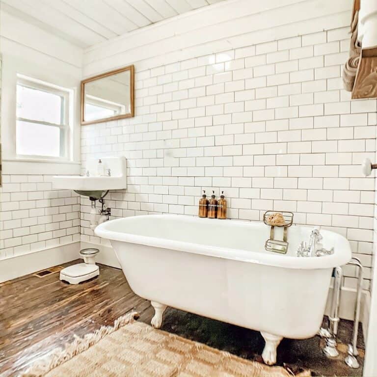 Freestanding Bathtub in White Subway Tile Bathroom