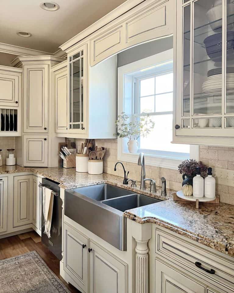 Glass Face Cupboards Above Beige Subway Tile Backsplash with Granite Countertops