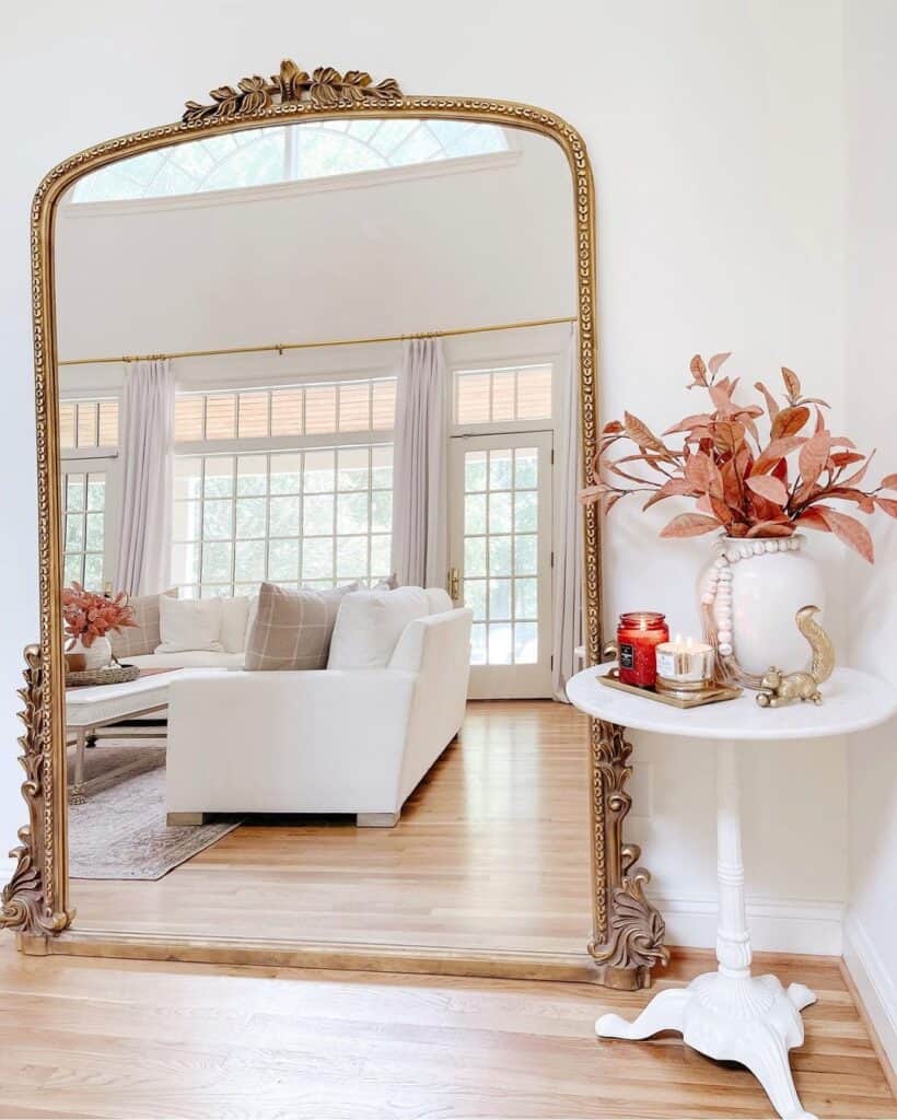 Gold Filigree Floor Mirror Reflecting White Living Room