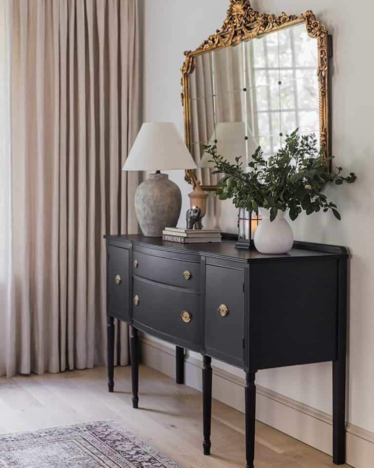 Gold Mirror Above a Black Buffet