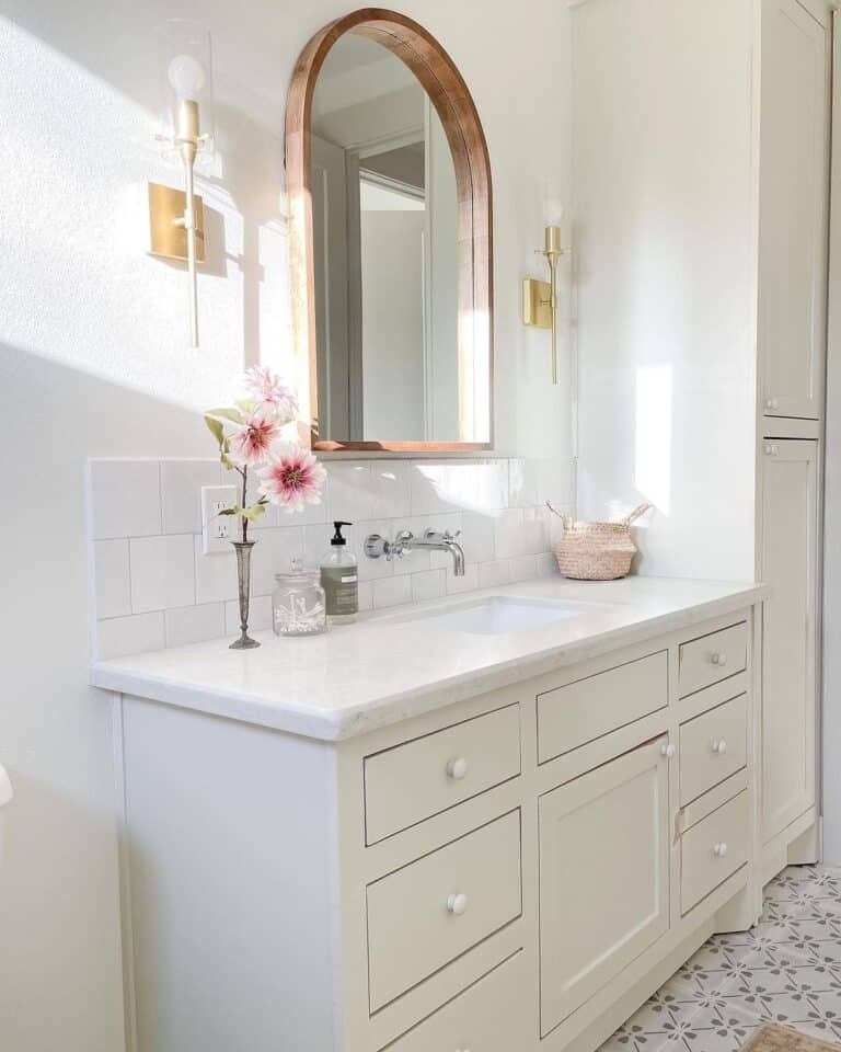 Gold Sconces and Square Tile Vanity Backsplash