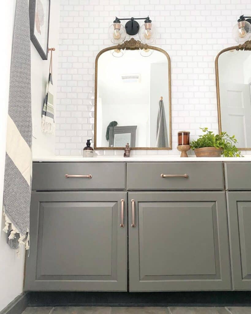 Gray Bathroom Vanity with Arched Brass Mirrors