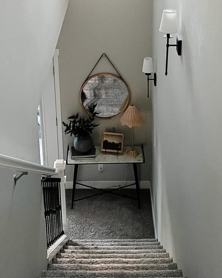 Gray Carpet Staircase with Black Shaded Sconces