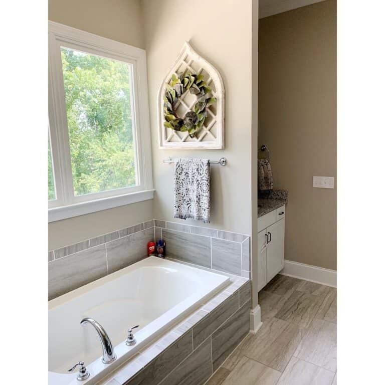 Gray Tile Backsplash Surrounds White Bathtub