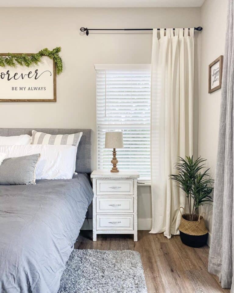 Gray and White Bed Accented with Ivory Curtain