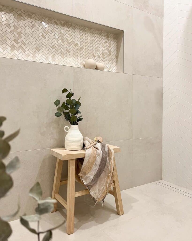 Green Branches Against a Wall with Large Beige Tiles