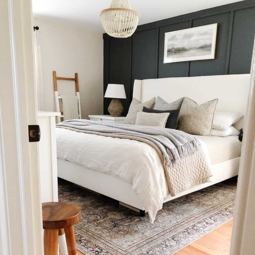 Grey Area Rug Under a Bed Covered by a White Comforter