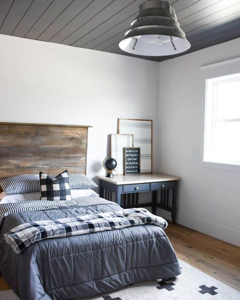 Grey Comforter on Bed With Wood Headboard