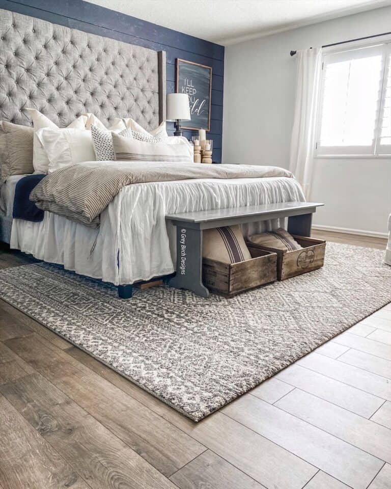 Grey Rug Under Bed on Warm Wood Floor