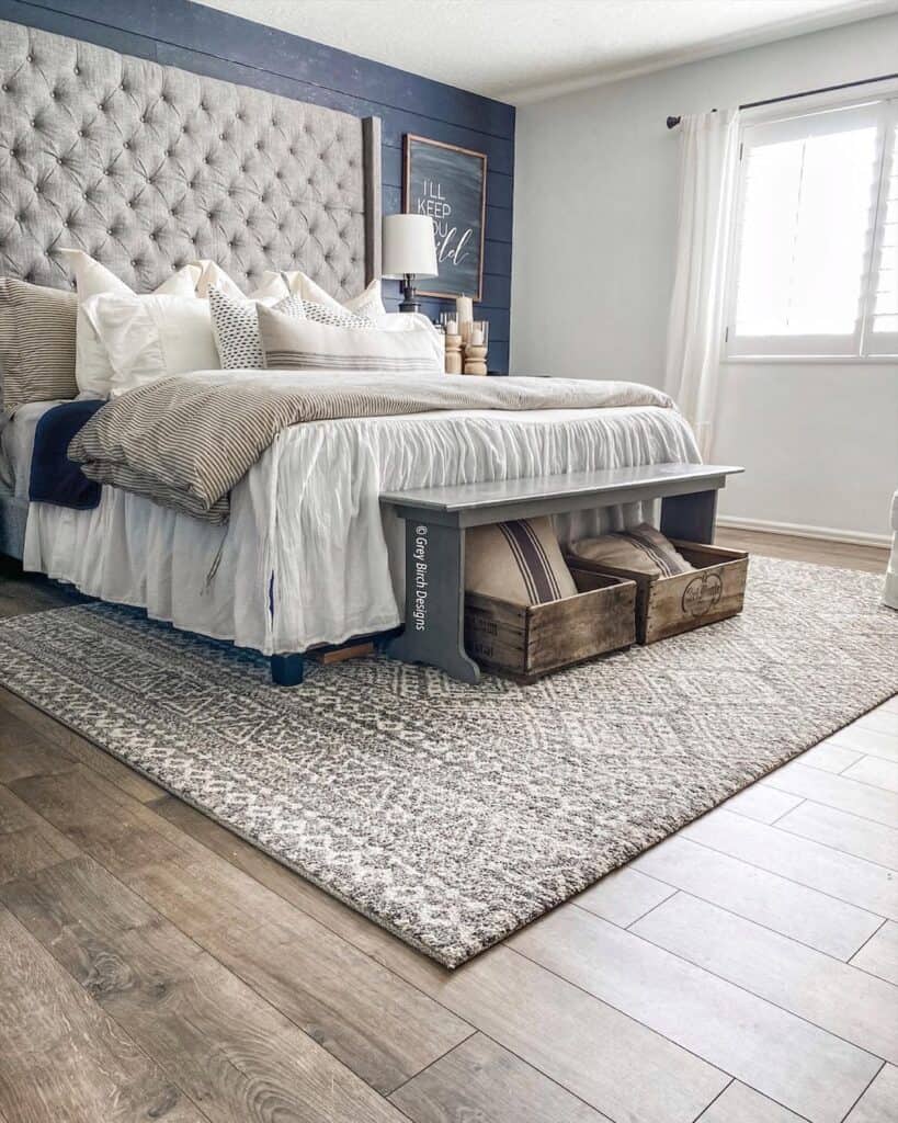 Grey Rug Under Bed on Warm Wood Floor