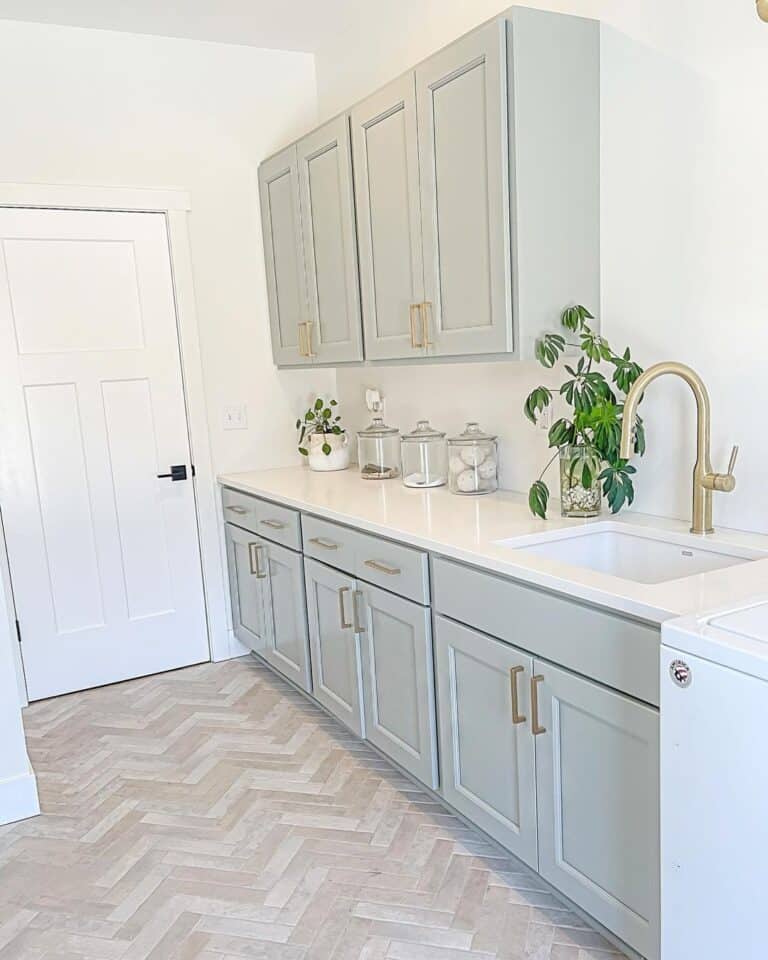 Herringbone Tile Laundry Room with Cabinets