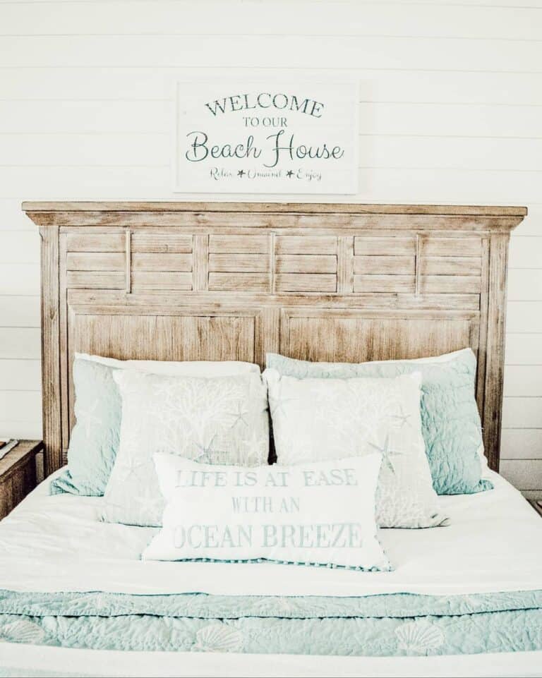 Light Wood Headboard With Blue and White Coverlet