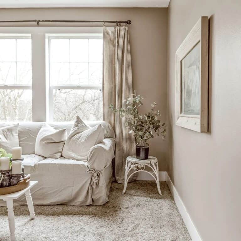 Linen Slipcover Couch Framed by Striped Drapes