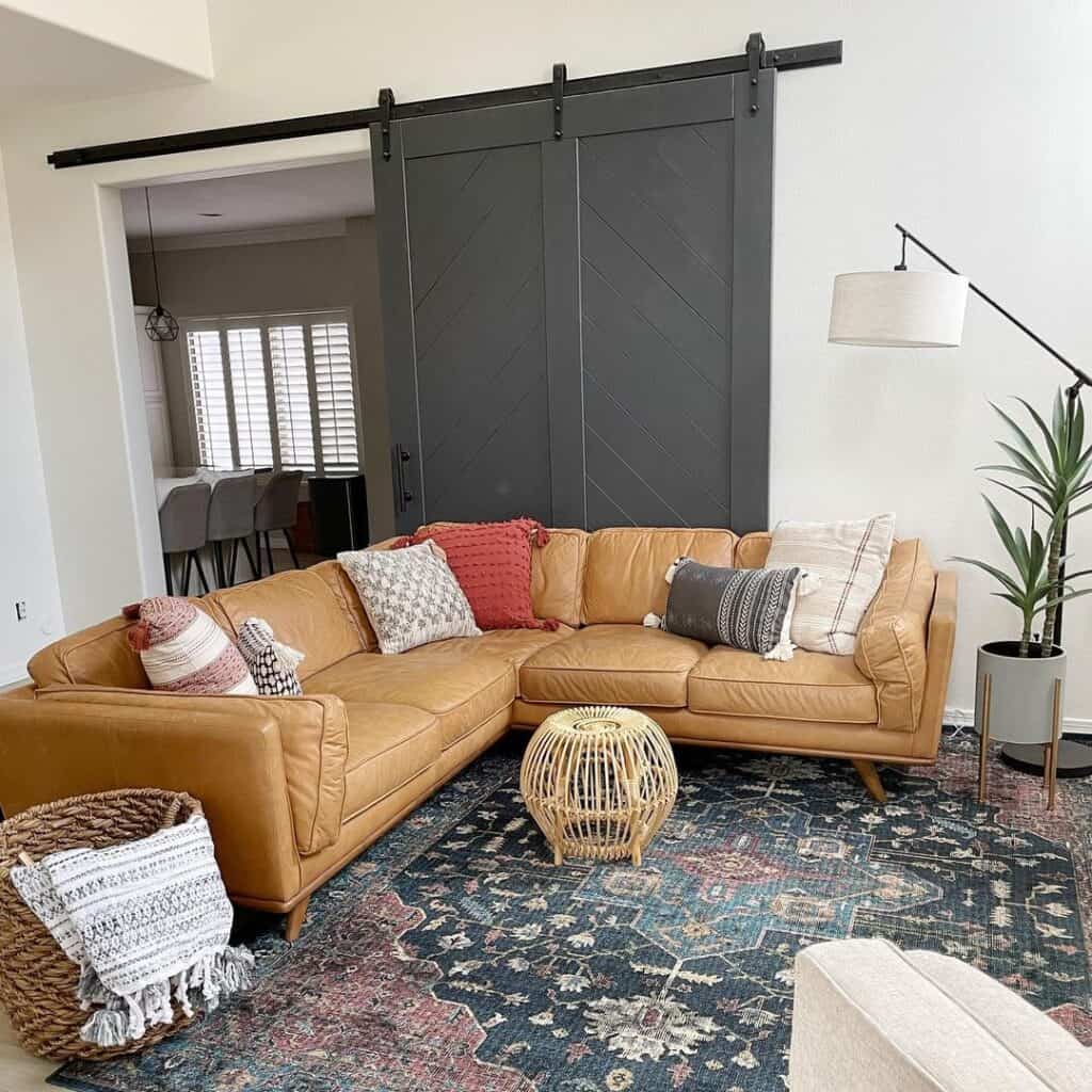 Living Room With Brown Leather Sofa and Sliding Barn Door