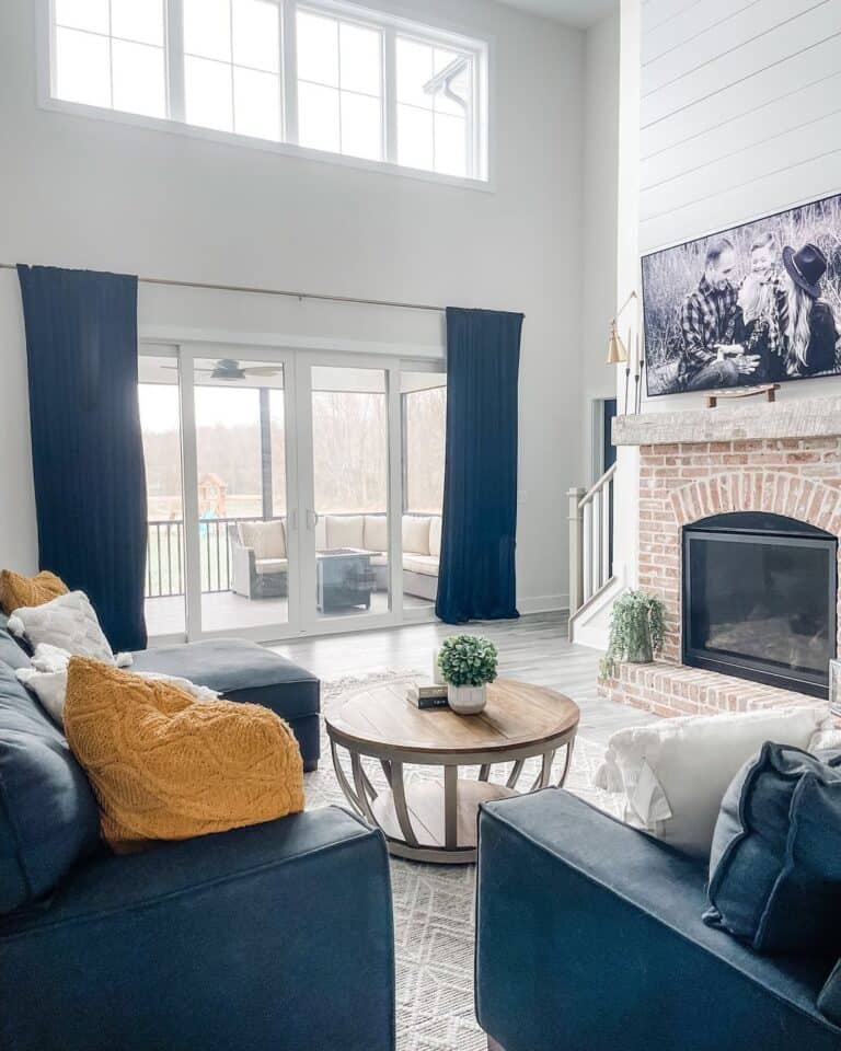 Living room with Brick and Shiplap Fireplace and Vaulted Ceiling