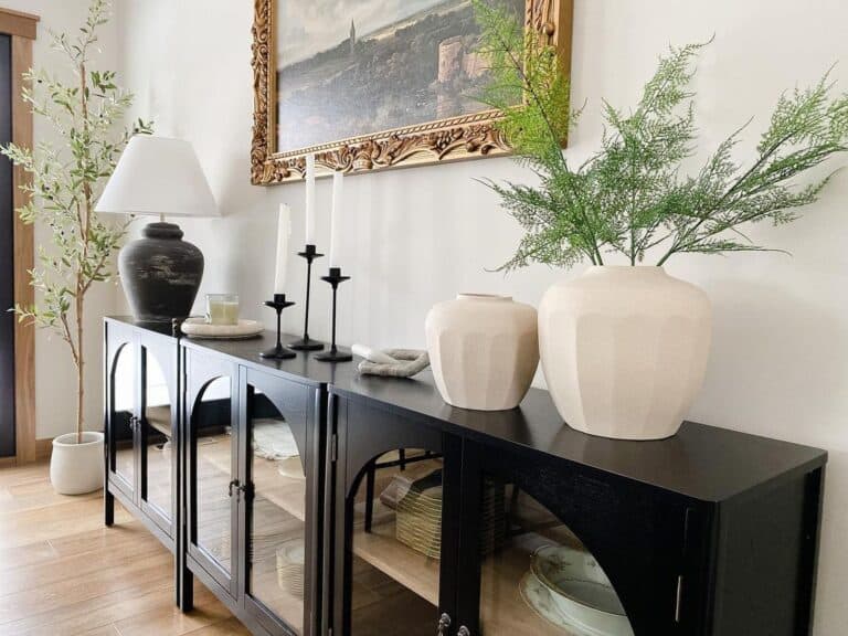 Long Black Sideboard Under Landscape in a Gold Frame
