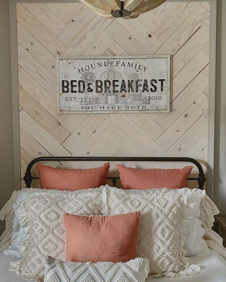 Metal Headboard Against Wood Herringbone Wall
