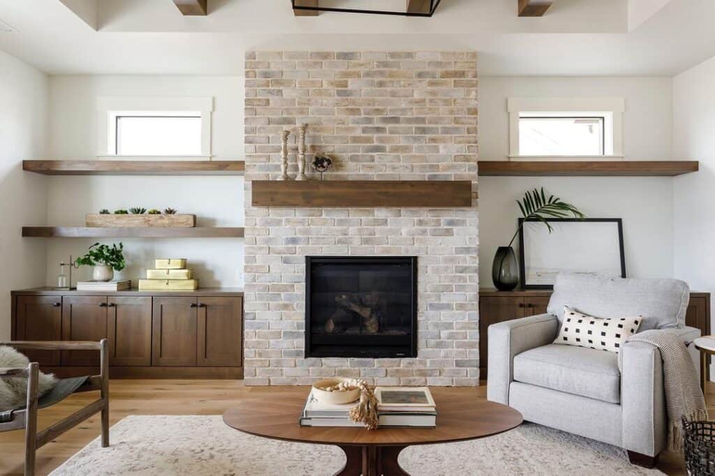 Modern Living Space With Brick Fireplace and Floating Shelves