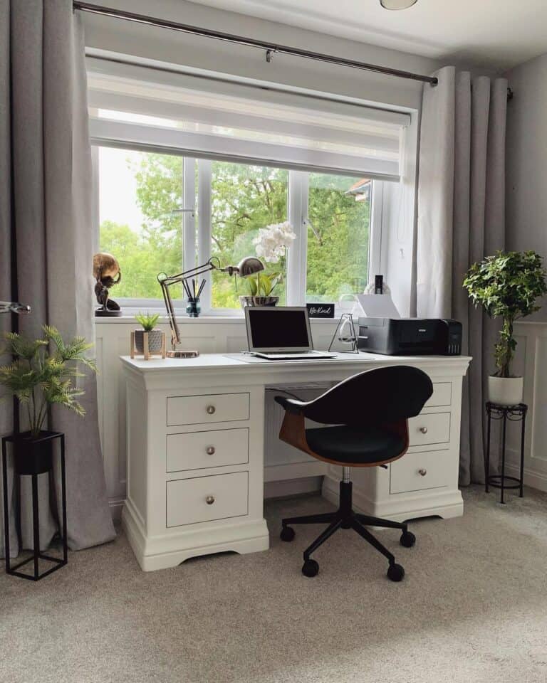 Modern White Desk With Drawers Under a Large Window