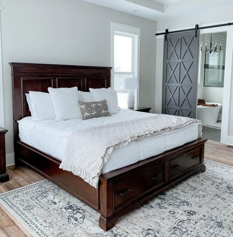 Off-White Area Rug Under Dark Wood Bed