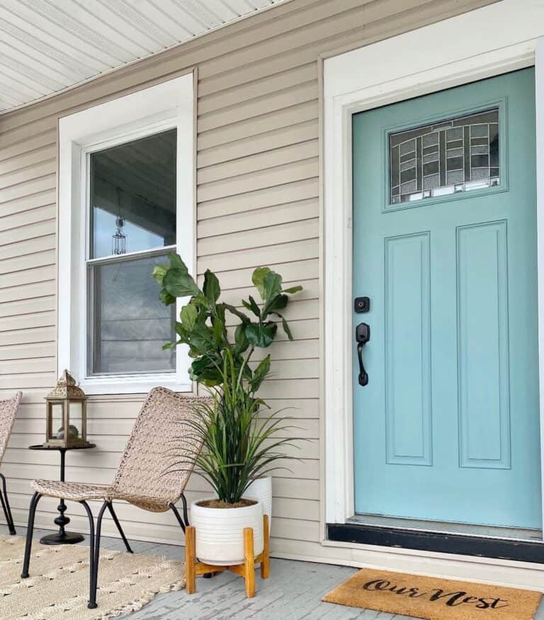 Pastel Blue Front Door on Neutral Porch