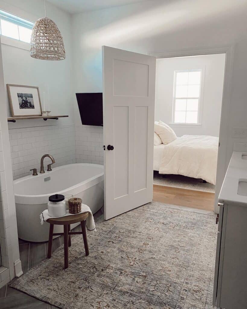 Patterned Rug Under Paneled Door to Bedroom