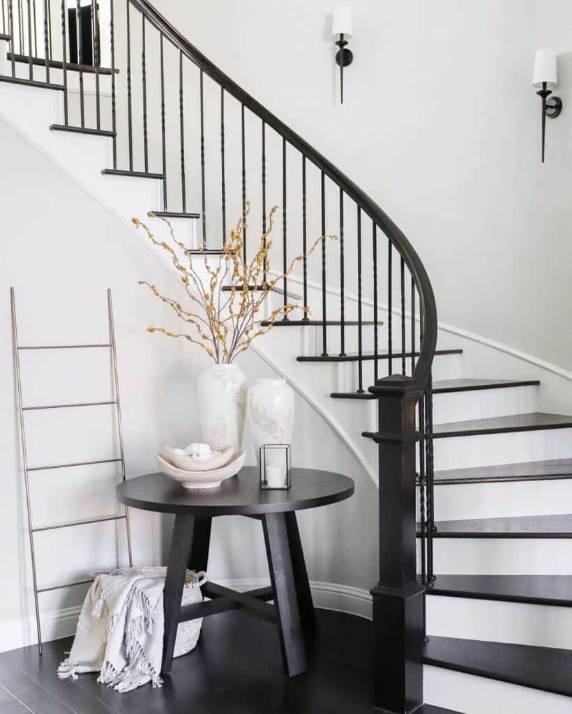 Round Black Table and Curved Black and White Stairs